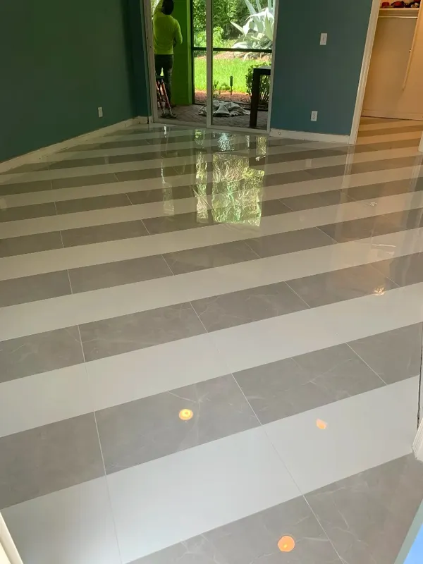Custom Striped Marble Floor — Bold alternating stripes of polished white and grey marble in a high-gloss, mirror-like finish.
