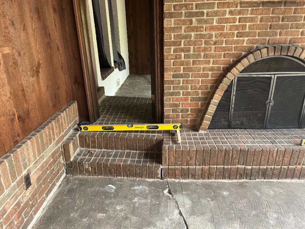 A level set across the brick hearth step and entry threshold to plan tile transitions